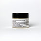 Jar of facial cream with black lid and white label on a white background